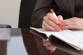 Hand writing Ask An Expert with black marker on transparent wipe board.