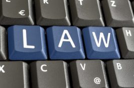 Word LAW written with blue keys on computer keyboard.